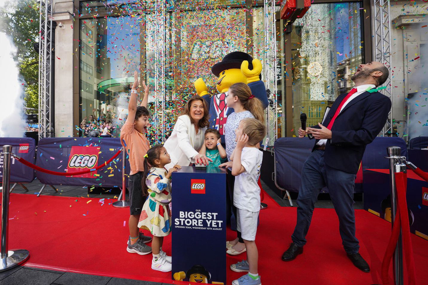 People pressing a button to reopen the Lego store